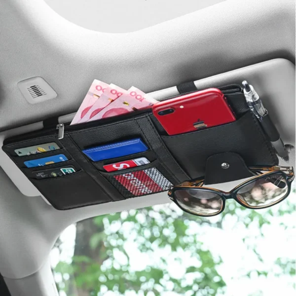 Sun visor organizer in black PU clipped onto a car visor holding pens and cards