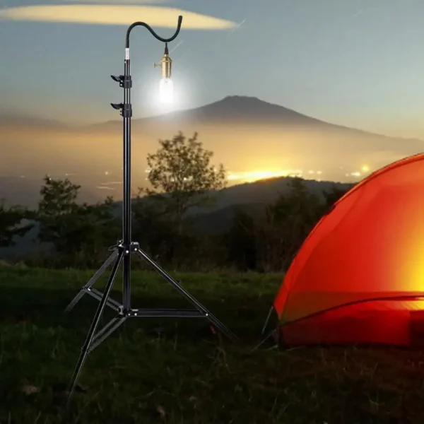 Camping light tripod stand extended with telescoping pole and three folding legs on grass