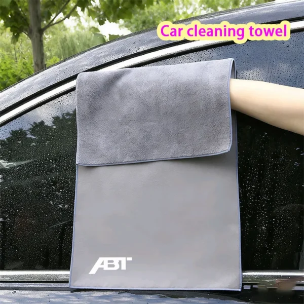 Lint free microfiber towel folded on a clean car dashboard next to the windshield