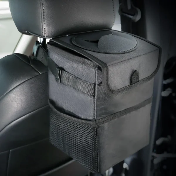 Black lidded car trash can hanging on a car seat back with the lid closed