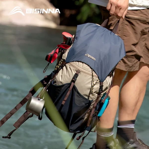 Ultralight hiking backpack in navy blue shown open and folded into its compact packed size