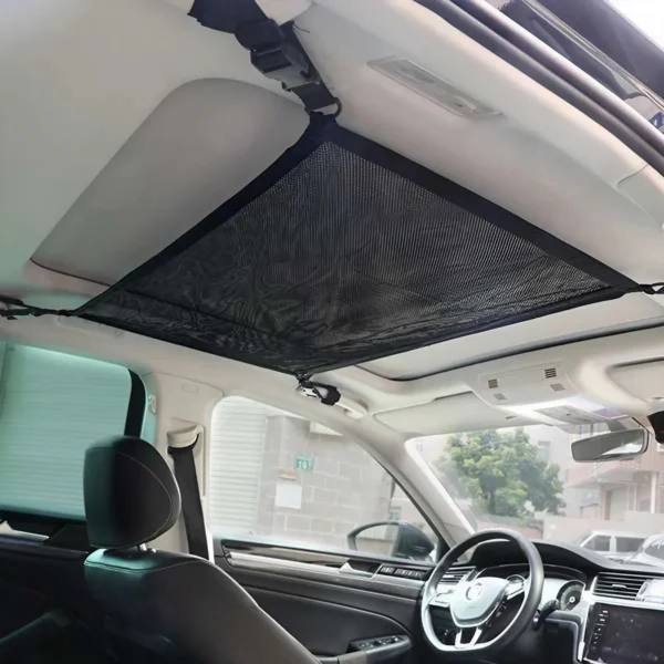 Zippered ceiling cargo net hanging under a car roof filled with jackets and towels