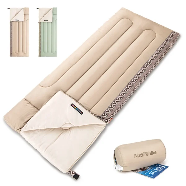 Cotton camping sleeping bag in green unrolled on a sleeping pad inside a tent