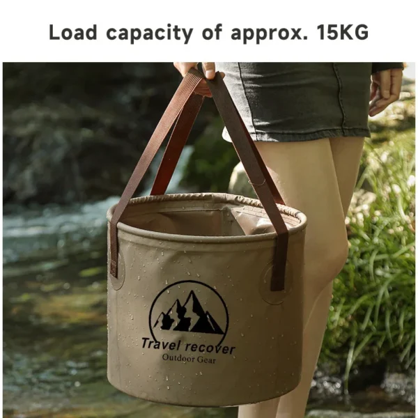 Collapsible camping bucket in PVC filled with water beside a folded spare at a campsite