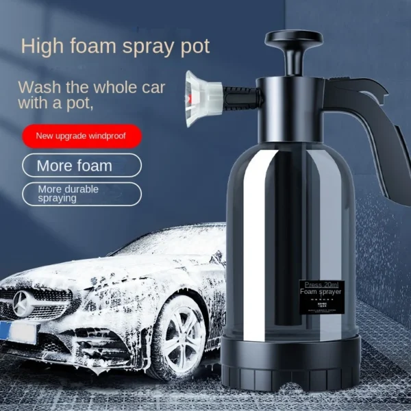 Hand pump foam sprayer with 2L bottle spraying snow foam onto a car wheel