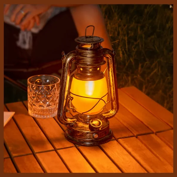 Flame effect lantern in a bronze iron frame with flickering candle style light inside