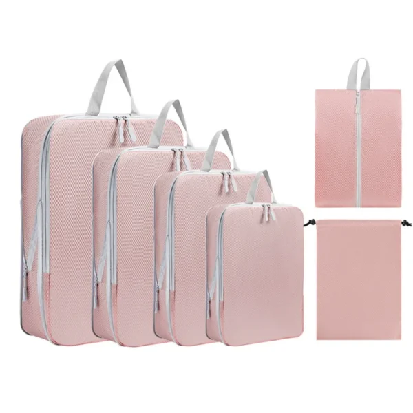 XL packing cube set in black with extra large cubes, small cube and shoe bag by a suitcase