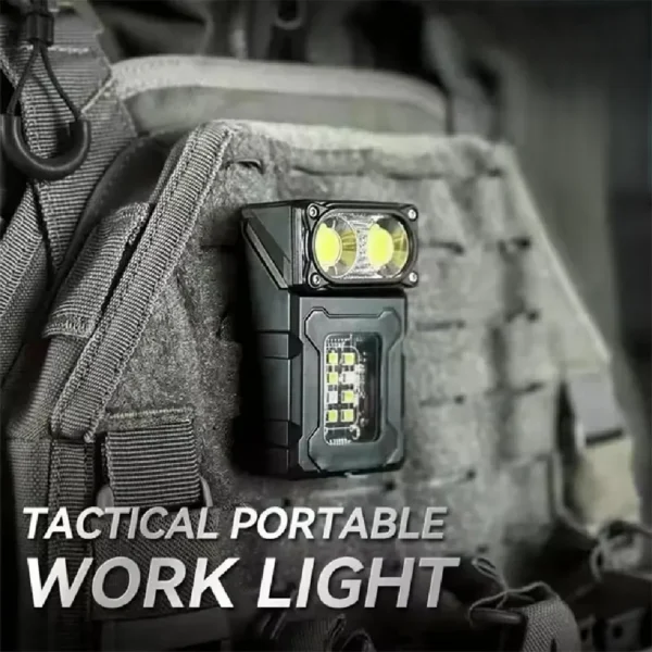 Magnetic mini camping light attached to a car door with its head rotated to light the ground
