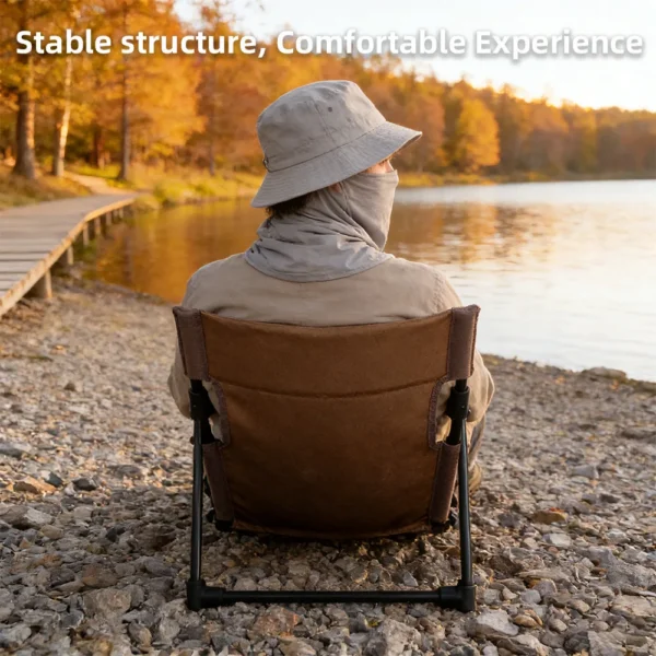 Breathable outdoor lounge chair in black set up beside a lake for fishing and relaxing