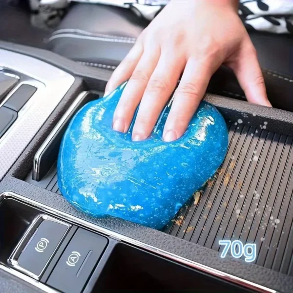 Car cleaning gel pressed into a dashboard air vent lifting dust from the slats