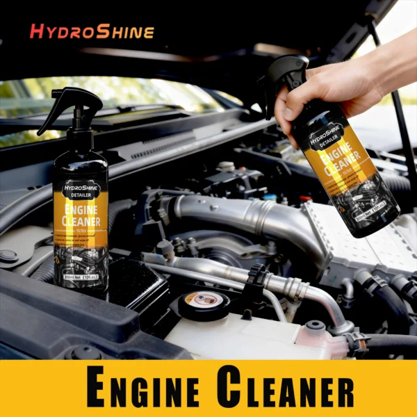 Engine bay cleaner spray bottle next to a freshly degreased car engine