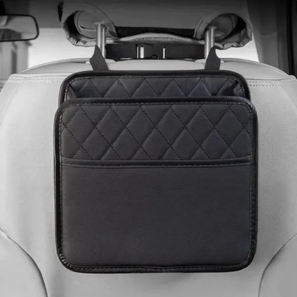 Folding leather backseat bag hanging behind a car seat holding a tablet and bottles