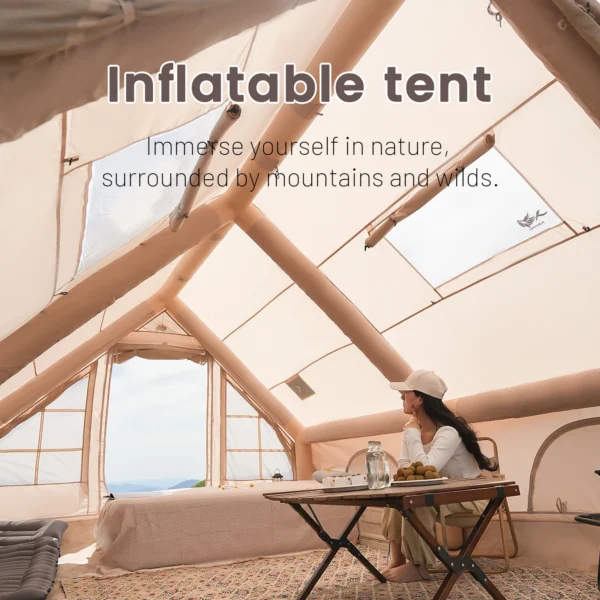 Inflatable camping tent in khaki with clear skylight pitched on grass at a family campsite