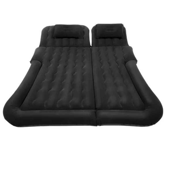 car air mattress with pump inflated across a car rear seat with two pillows and the pump beside it