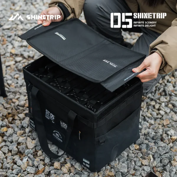 32L tactical storage bag in Oxford fabric packed with picnic and camp kitchen gear beside a car