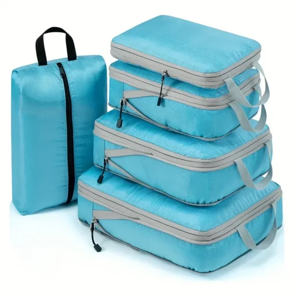 Waterproof nylon packing cubes set in three sizes, packed with folded clothes in a suitcase