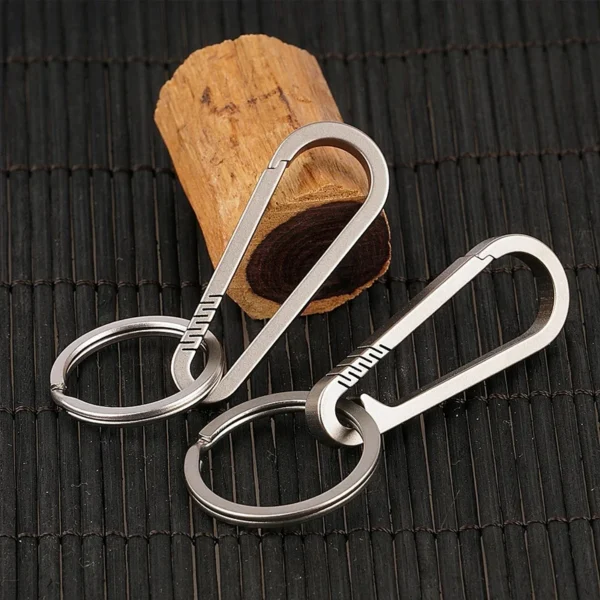 Titanium carabiner keychain with quick release buckle holding a set of car keys