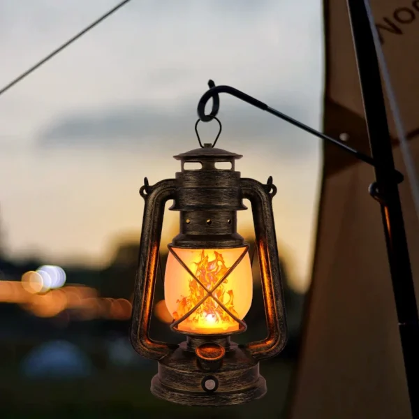 Touch dimming flame lantern in a bronzing finish on a camp table with flame light glowing