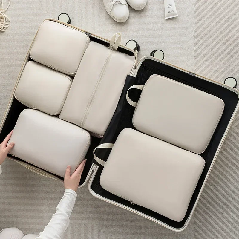 6 Piece Packing Cubes Set with Handbag, Compressible Polyester 1 Grey 6 piece packing cubes set with matching handbag laid out beside a suitcase