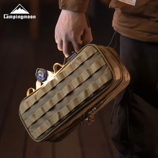 Black double layer tactical handbag open to show two storage levels with camping tools inside