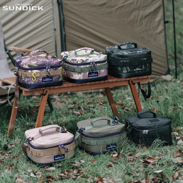 Camping bowl storage bag in army green holding stacked camp bowls and cups on a picnic table