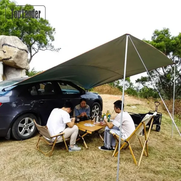 Car side awning tarp in olive green set up with aluminum poles beside an SUV