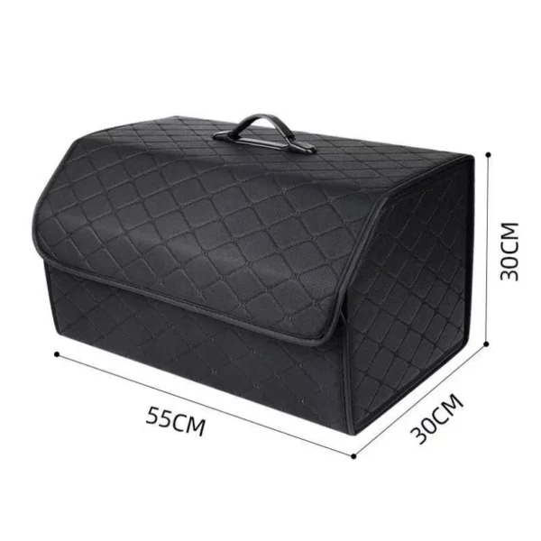 Leather trunk storage box in black with red stitching sitting open in a car trunk