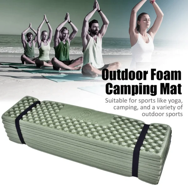 Folding foam sleeping pad with egg crate pattern unfolded on the ground at a campsite