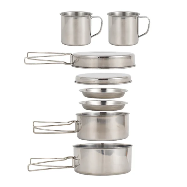Stainless steel mess kit with two pots, frying pan, plates and cups spread out on a camp table