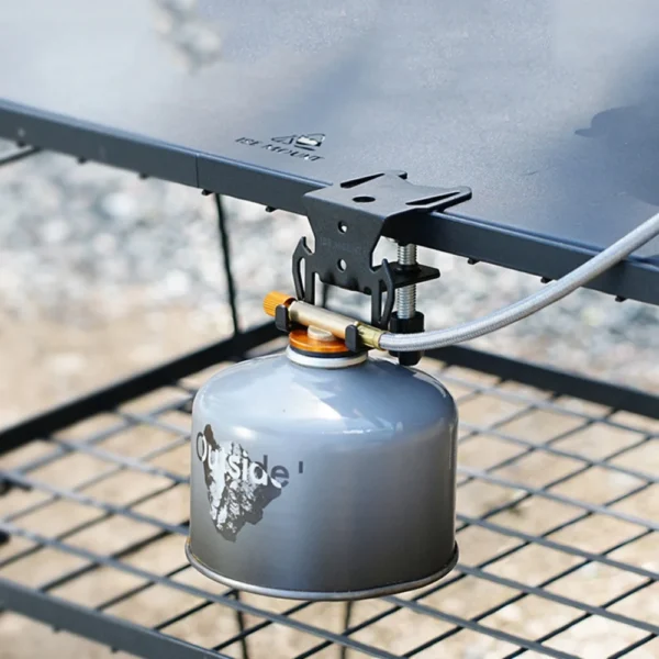 Table gas tank hook in black clamped to a camp table edge with a hanging plate and canister