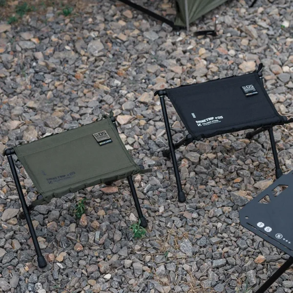 ShineTrip tactical folding stool in sand color with Oxford seat and aluminum bracket at camp