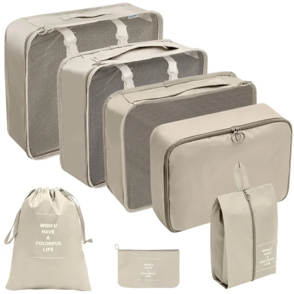 Large packing cube set laid out with clothes cubes and shoe bags beside an open suitcase