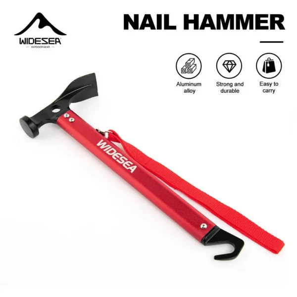 Red aluminum tent stake hammer next to metal tent pegs and a guyline on campsite grass