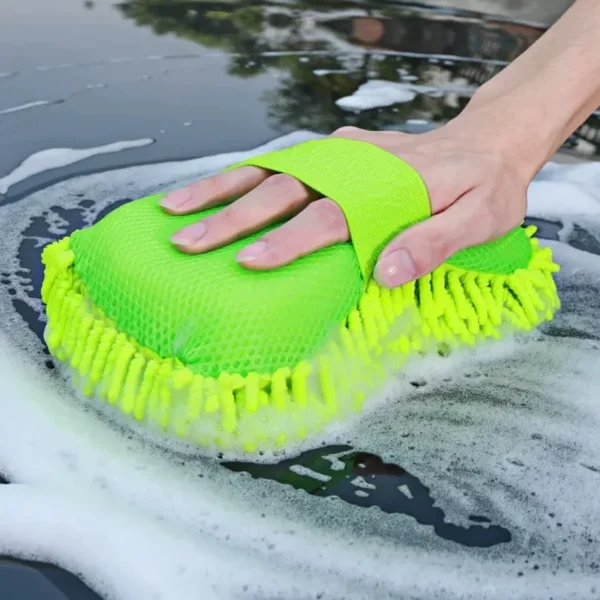 Microfiber car washer sponge in blue resting on the hood of a soapy car