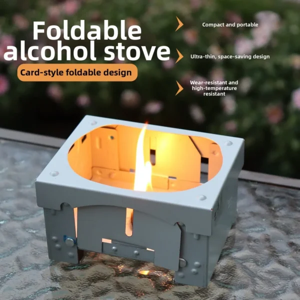 Folding alcohol stove in stainless steel unfolded on a rock with a small pot ready to heat