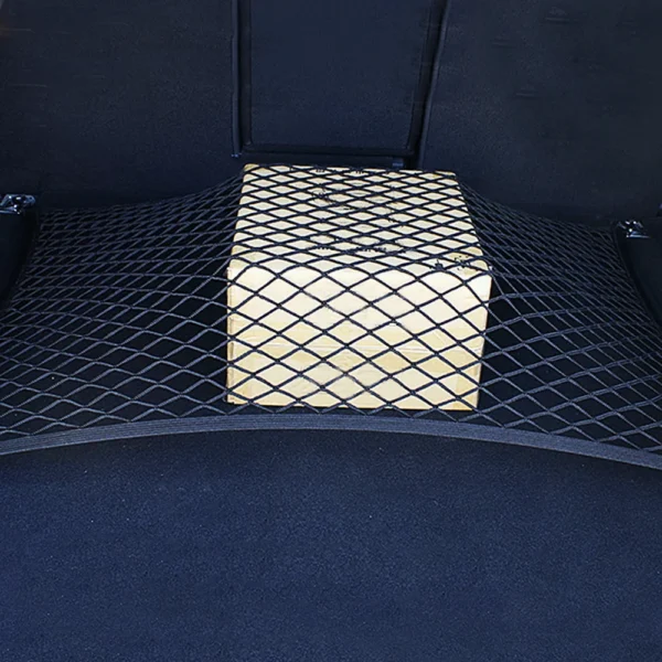 Elastic trunk luggage net hooked to four loops holding bags in a car trunk