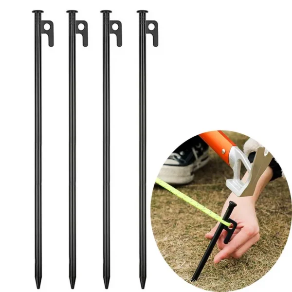 Thick iron tent pegs in three lengths lined up next to a mallet on grass