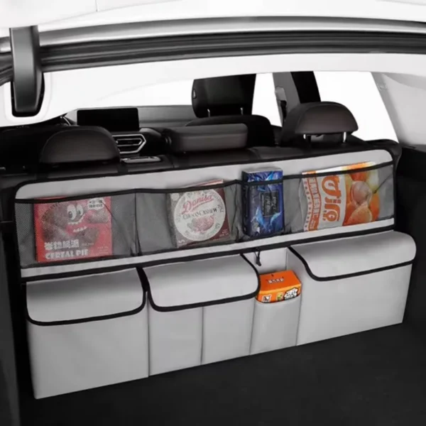 Gray seat back mesh bag hanging behind a front seat holding bottles and snacks