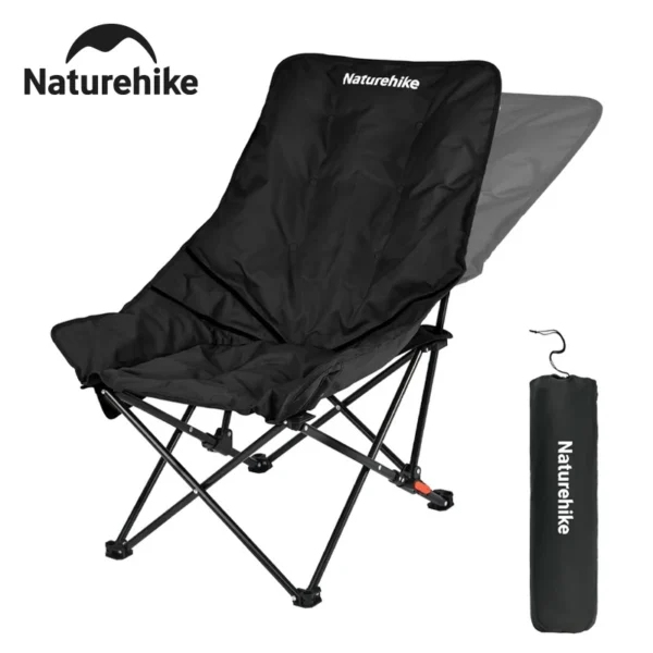 Naturehike high back moon chair in green reclined beside a campfire at a forest campsite