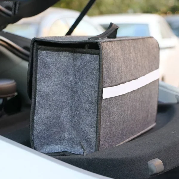 Collapsible felt cargo box set up in a car trunk holding bottles, tools and supplies