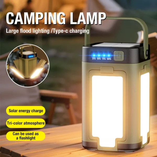 Tri color camping light in green with four panels folded out and glowing warm yellow