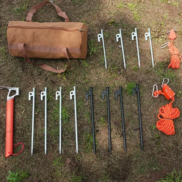 Canvas tent stake holder in blue with tent pegs and stakes packed inside on campsite grass