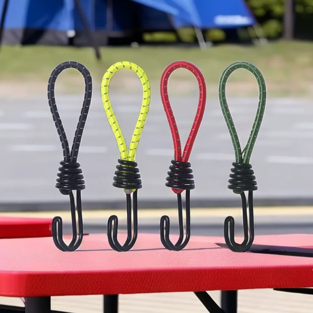 Rubber Tent Bungee Cords with Coated Hooks 10 Pack 1 Rubber tent bungee cords in yellow with coated hooks fastening a tent fly to stakes