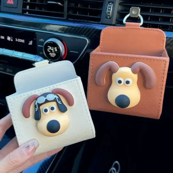 Air vent storage pocket hanging from a car vent with a phone tucked inside
