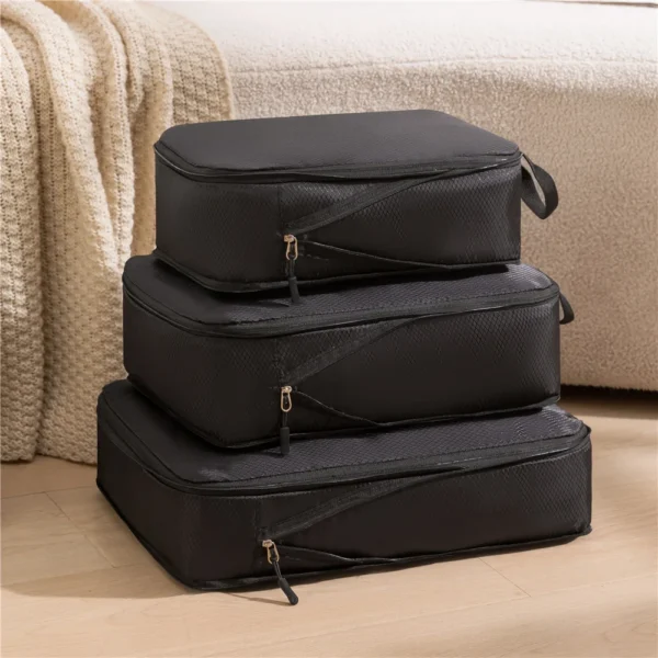 3 piece compressible cubes in gray Oxford fabric packed with folded clothes in a suitcase