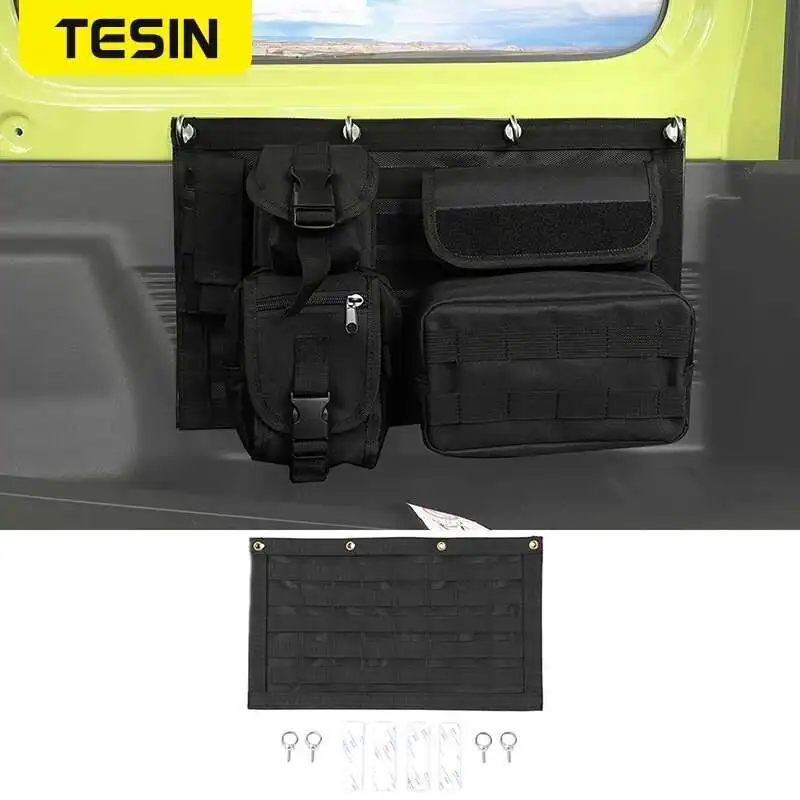 Tailgate Pocket Organizer for Suzuki Jimny JB64 JB74 TESIN 1 Black tailgate pocket organizer with tool pockets mounted on a Suzuki Jimny rear door