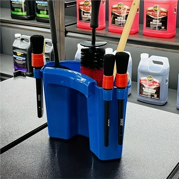 Detailing bucket organizer clipped to the side of a wash bucket holding several detailing brushes
