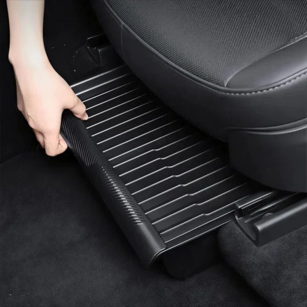 Black under seat storage box with lid placed under a front seat in a Tesla Model Y