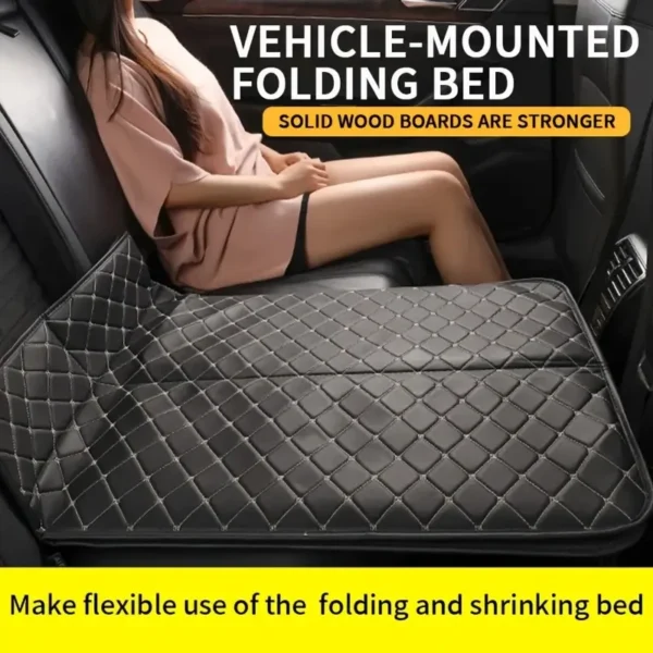 Car backseat bed in black faux leather unfolded across the rear seat of a vehicle