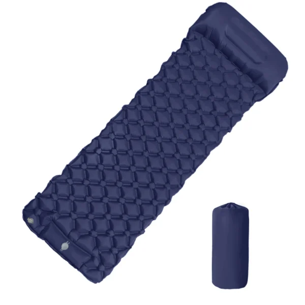 Ultralight inflatable sleeping pad with attached pillow laid out inside a camping tent